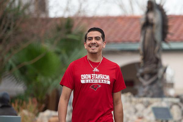 Pastoral Ministry student walking through campus outdoors